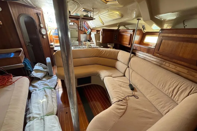 Slide: The Image of Interior of 1994 Hunter Legend 40.5 sailboat with beige seating and wooden accents. - 10