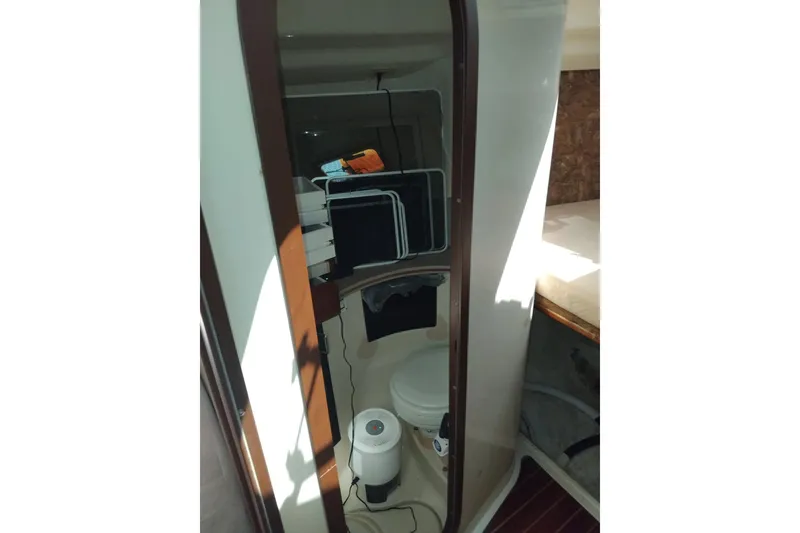 Slide: The Image of Interior of 1994 Hunter Legend 40.5 sailboat bathroom with toilet and storage shelves. - 15