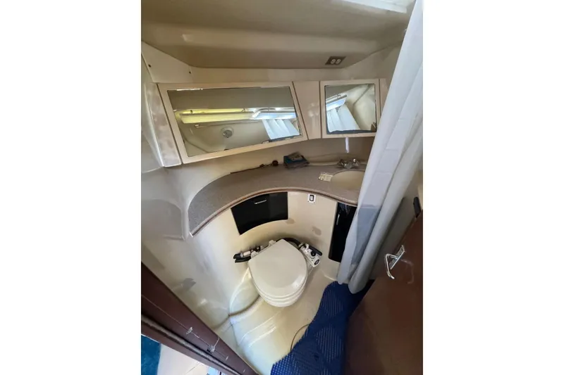 Slide: The Image of 1994 Hunter Legend 40.5 yacht bathroom with mirrors, sink, and toilet. - 16