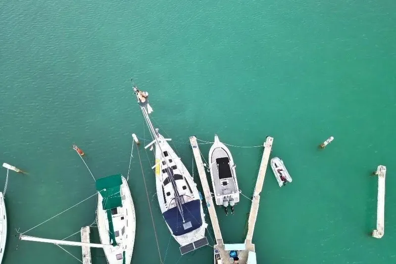 Slide: The Image of Aerial view of 1994 Hunter Legend 40.5 sailboat docked in turquoise water. - 17
