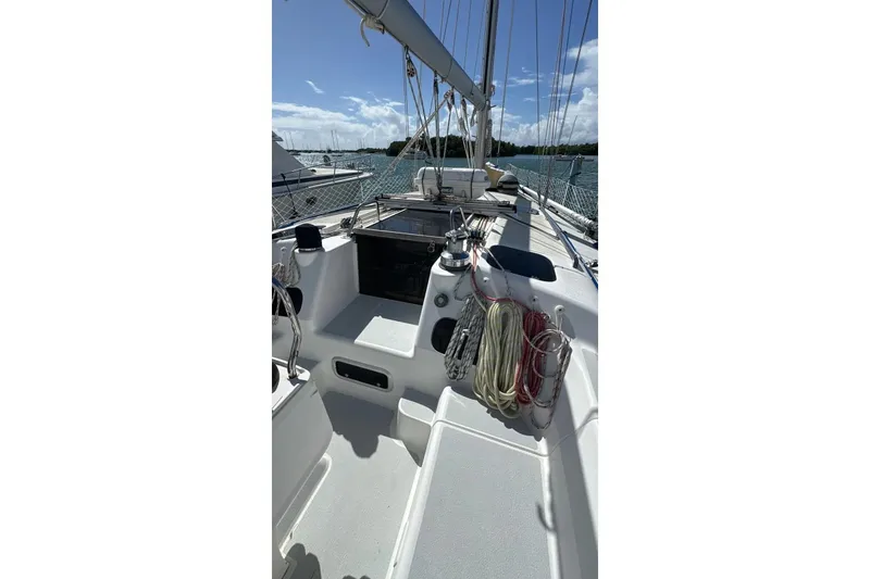 Slide: The Image of Sailboat deck of 1994 Hunter Legend 40.5, featuring ropes and winches under clear skies. - 2