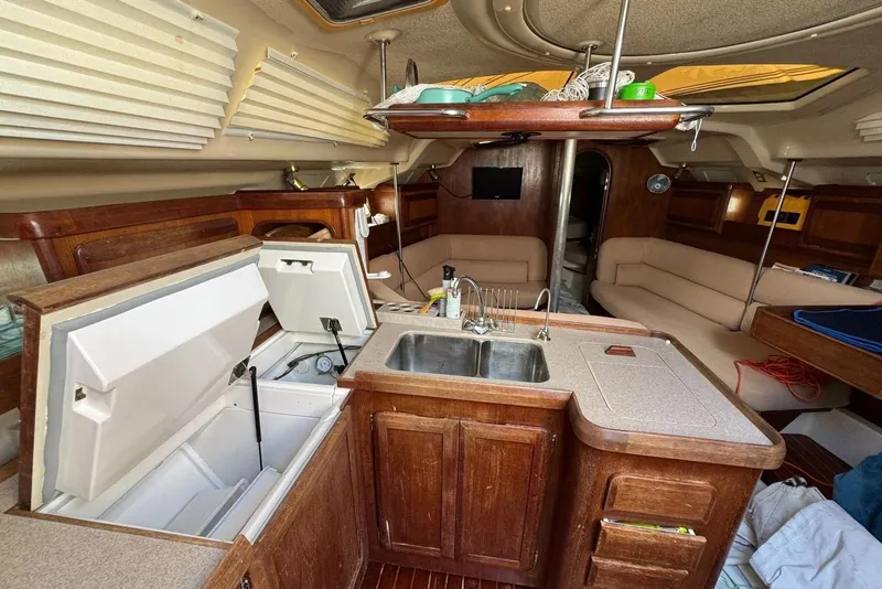Slide: The Image of Interior of a 1994 Hunter Legend 40.5 sailboat with kitchen and seating area. - 6