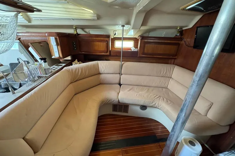 Slide: The Image of Interior of 1994 Hunter Legend 40.5 sailboat with cozy seating and wooden accents. - 8