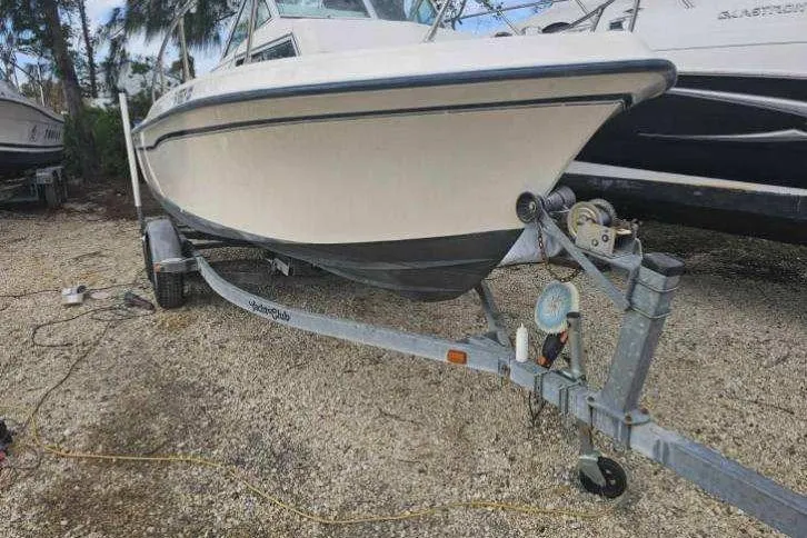 Slide: The Image of 1989 Grady-White Overnighter 204 boat on trailer, parked outdoors. - 4