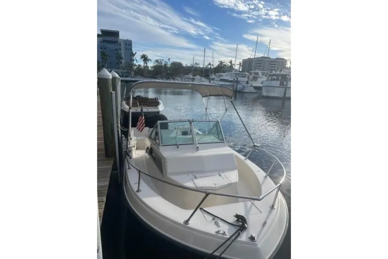 The Image of 1989 Grady-White Overnighter 204 boat docked at a marina under a clear sky. - 5