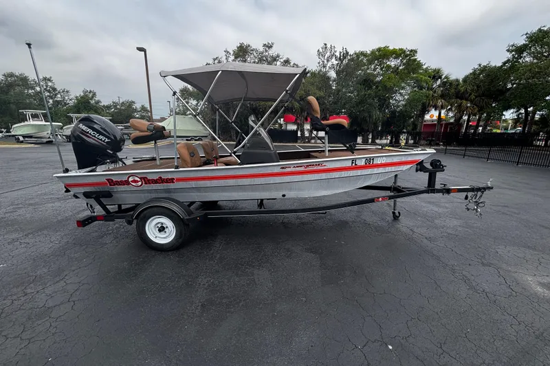 The Image of 2018 Tracker Bass Tracker 40th Anniversary Heritage Edition boat with trailer in parking lot. - 1