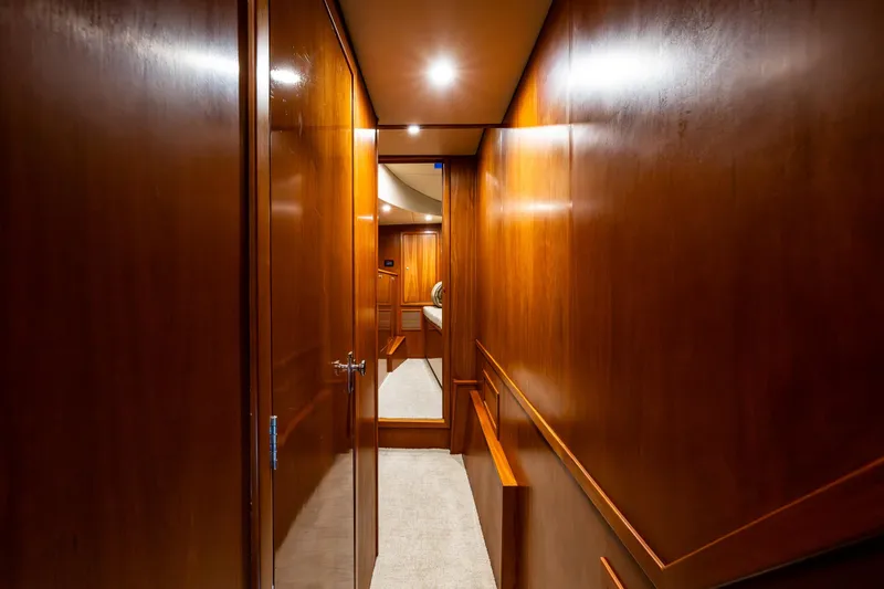 Slide: The Image of Luxurious wooden hallway interior of 2009 Northwest Powercats 58 yacht, featuring elegant lighting. - 13