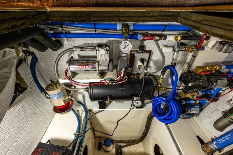 Slide: The Image of Engine room of 2009 Northwest Powercats 58, showcasing mechanical components and wiring. - 17
