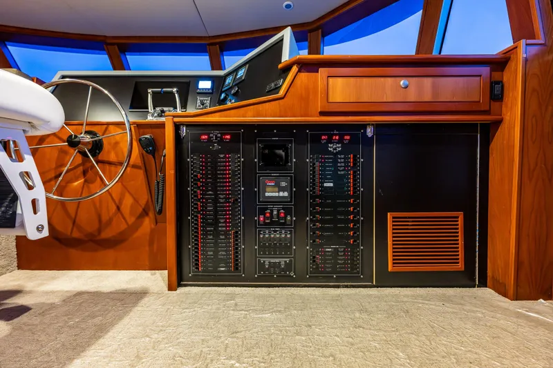 Slide: The Image of Control panel and steering wheel of a 2009 Northwest Powercats 58 yacht interior. - 23