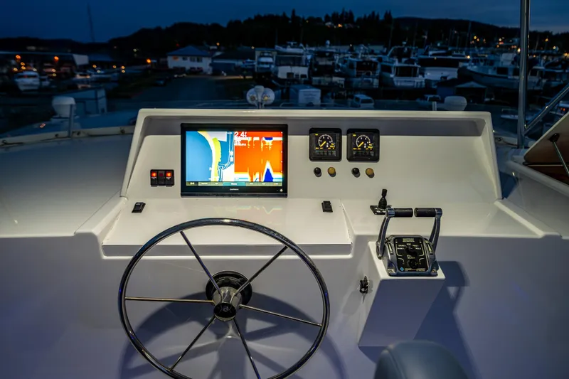 Slide: The Image of Helm of 2009 Northwest Powercats 58 with navigation screen and controls at marina. - 30