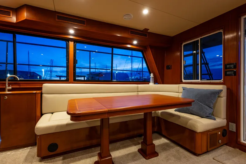 Slide: The Image of Luxurious interior of 2009 Northwest Powercats 58 yacht with elegant dining area and scenic window views. - 32