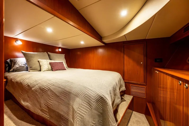 Slide: The Image of Luxurious cabin interior of 2009 Northwest Powercats 58 yacht with cozy bedding and warm lighting. - 34