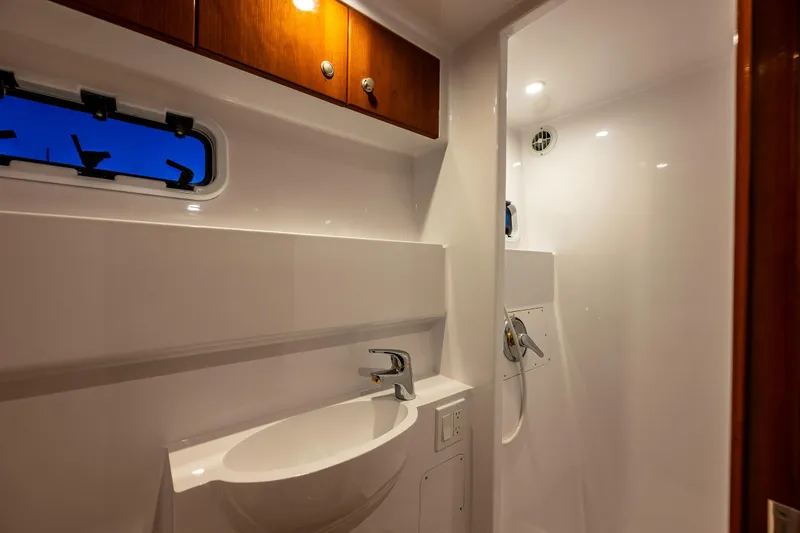 Slide: The Image of Luxurious bathroom interior of 2009 Northwest Powercats 58 yacht, featuring modern fixtures and wood accents. - 36