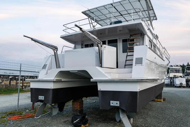 Slide: The Image of 2009 Northwest Powercats 58 catamaran on land, showcasing rear view and structure. - 4