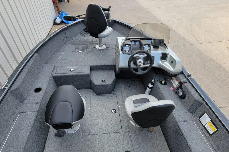 Slide: The Image of 2019 Tracker Pro Guide V-175 SC boat interior with gray seating and steering console. - 10