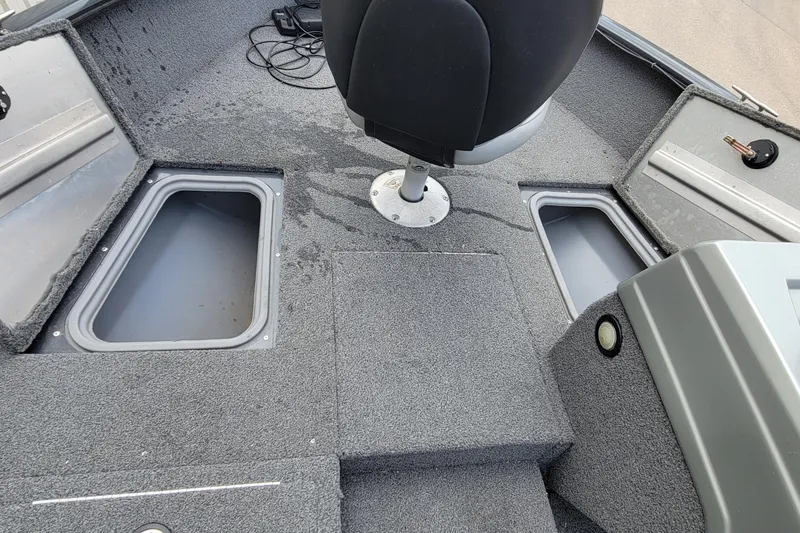 Slide: The Image of 2019 Tracker Pro Guide V-175 SC boat interior with fishing equipment and seating. - 13