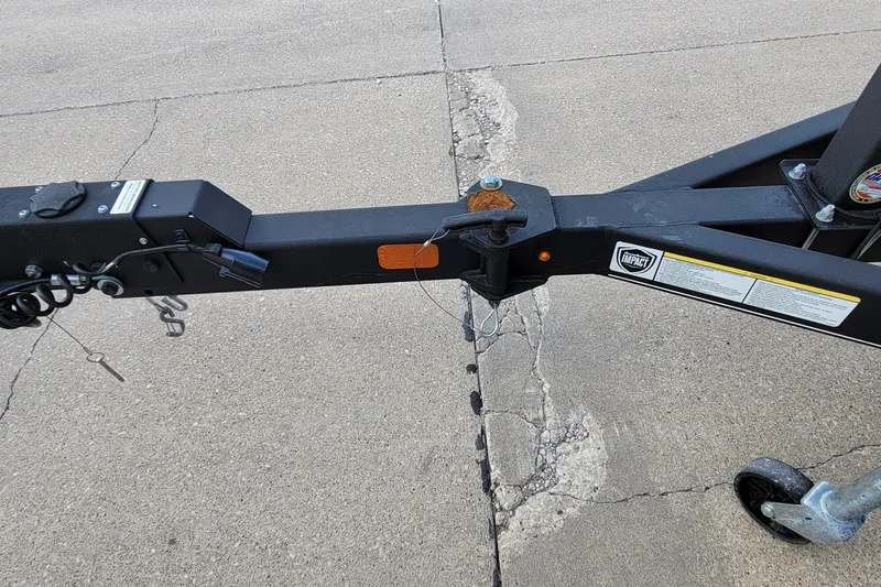 Slide: The Image of 2019 Tracker Pro Guide V-175 SC boat interior with carpeted flooring and a metal bracket. - 25