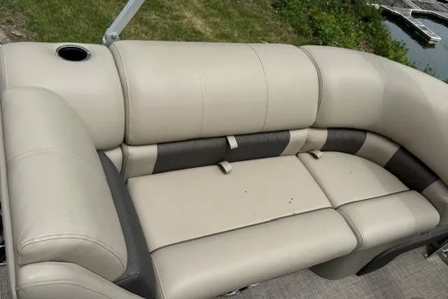 Slide: The Image of 2024 Sun Tracker Party Barge 22 RF XP3 beige seating with cup holder, near water. - 12
