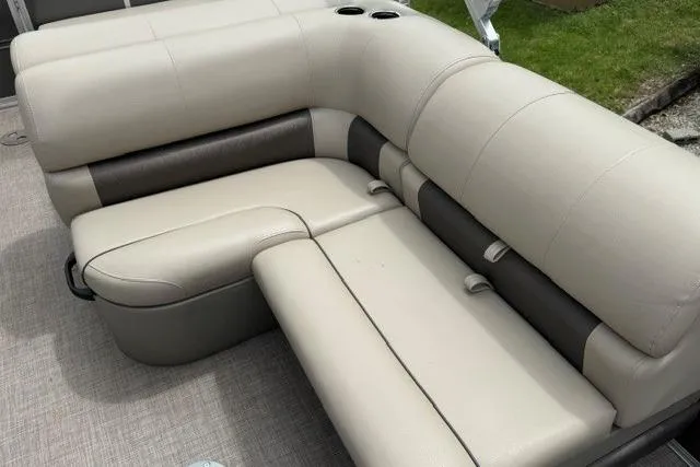 Slide: The Image of 2024 Sun Tracker Party Barge 22 RF XP3 seating area with beige and brown upholstery. - 17