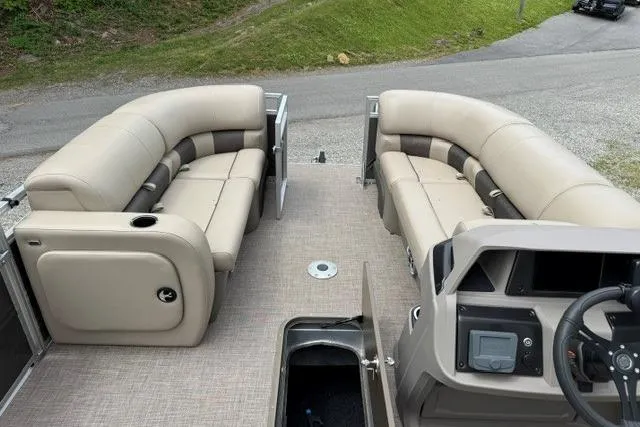 Slide: The Image of 2024 Sun Tracker Party Barge 22 RF XP3 interior with plush seating and modern dashboard. - 26