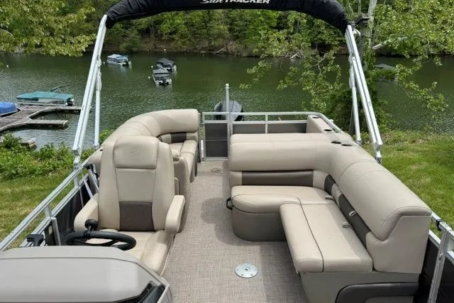 Slide: The Image of 2024 Sun Tracker Party Barge 22 RF XP3 pontoon boat with spacious seating on a serene lake. - 3