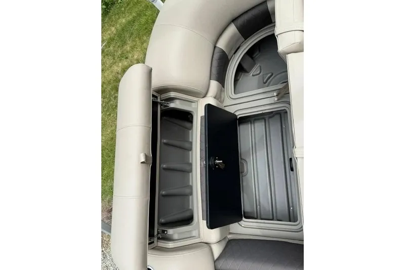 Slide: The Image of 2024 Sun Tracker Party Barge 22 RF XP3 storage compartment with open lid. - 4