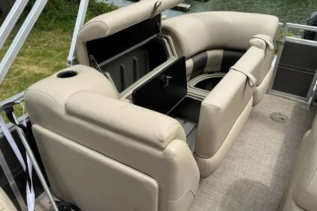 Slide: The Image of 2024 Sun Tracker Party Barge 22 RF XP3 interior with beige seating and storage compartments. - 6