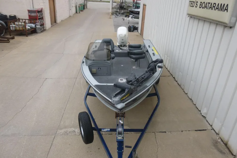 Slide: The Image of 2005 Lund Mr. Pike 16 fishing boat on trailer outside Ted's Boatarama. - 1