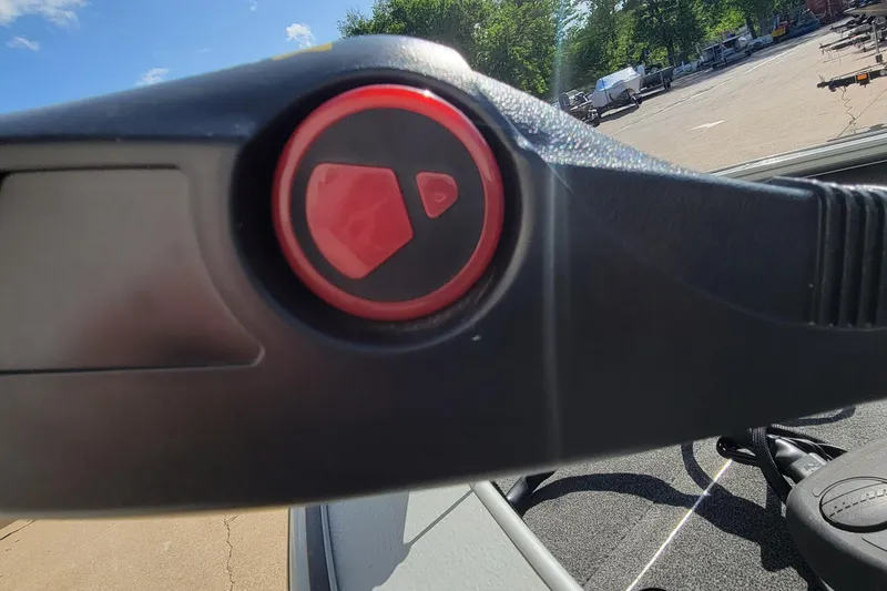 Slide: The Image of Close-up of a 2005 Lund Mr. Pike 16 boat control lever with red button. - 10