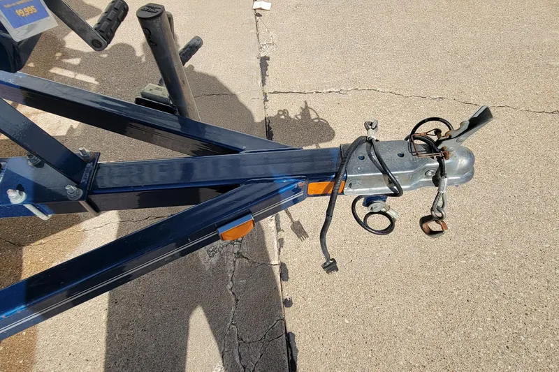 Slide: The Image of Trailer hitch of a 2005 Lund Mr. Pike 16 boat on concrete surface. - 14