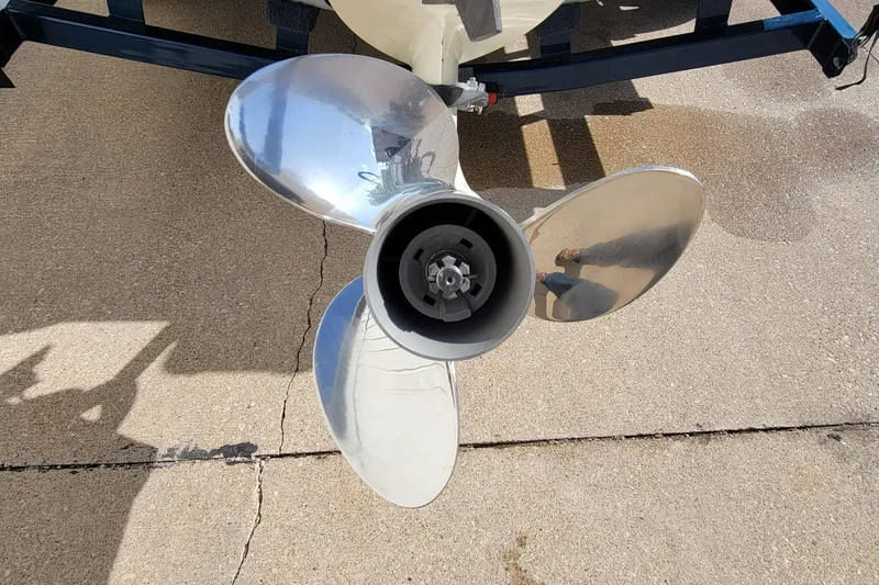 Slide: The Image of Close-up of a 2005 Lund Mr. Pike 16 boat propeller on pavement. - 19