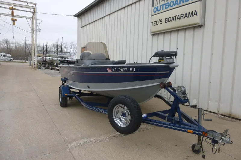 Slide: The Image of 2005 Lund Mr. Pike 16 boat on trailer outside Ted's Boatarama. - 3