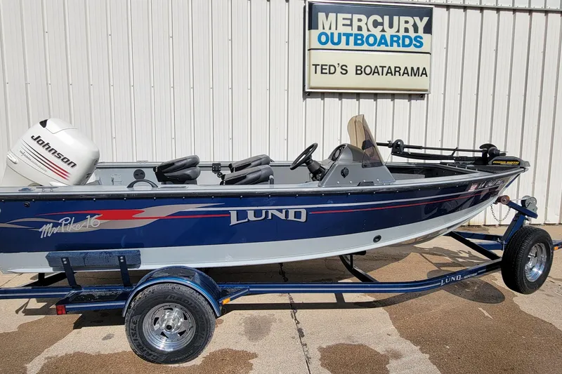 Slide: The Image of 2005 Lund Mr. Pike 16 boat with Johnson outboard motor on trailer at Ted's Boatarama. - 5