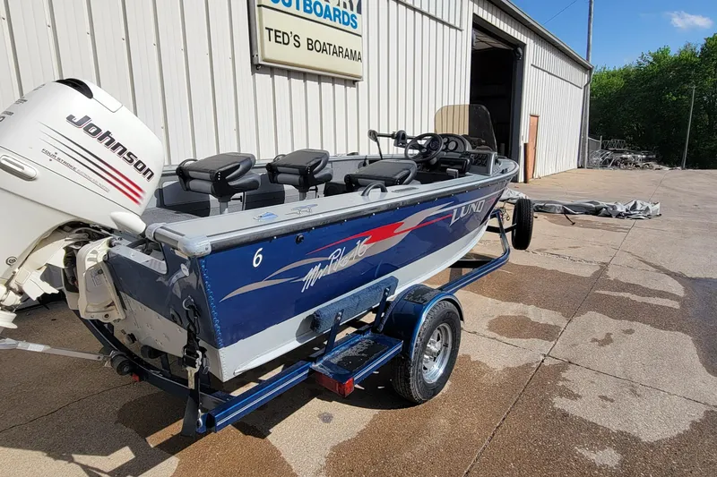 Slide: The Image of 2005 Lund Mr. Pike 16 boat with Johnson outboard motor at Ted's Boatarama. - 7