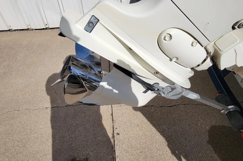 Slide: The Image of 2005 Lund Mr. Pike 16 boat motor with shiny propeller on concrete surface. - 8