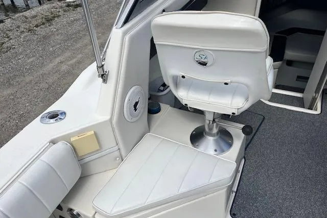 Slide: The Image of 1996 Sea Ray Laguna 24 Flushdeck Cuddy interior with white seating and marine speaker. - 12
