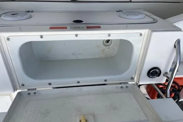 Slide: The Image of Open storage compartment on 1996 Sea Ray Laguna 24 Flushdeck Cuddy boat. - 13