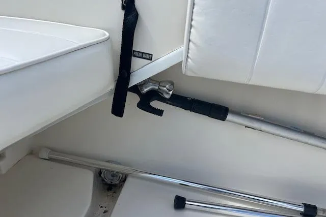 Slide: The Image of 1996 Sea Ray Laguna 24 Flushdeck Cuddy interior with boat hook and seating. - 15