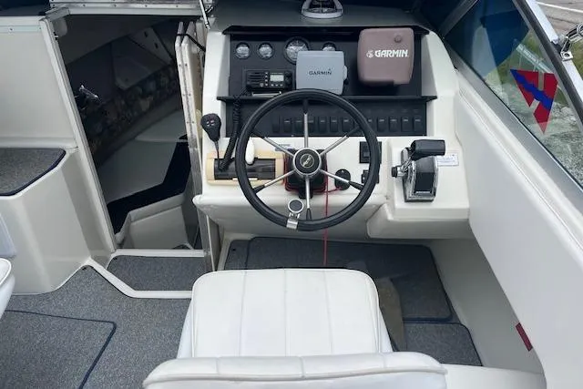 Slide: The Image of 1996 Sea Ray Laguna 24 Flushdeck Cuddy cockpit with steering wheel, Garmin navigation, and control panel. - 4