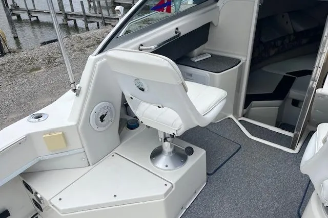 Slide: The Image of 1996 Sea Ray Laguna 24 Flushdeck Cuddy interior with white seating and carpeted flooring. - 7