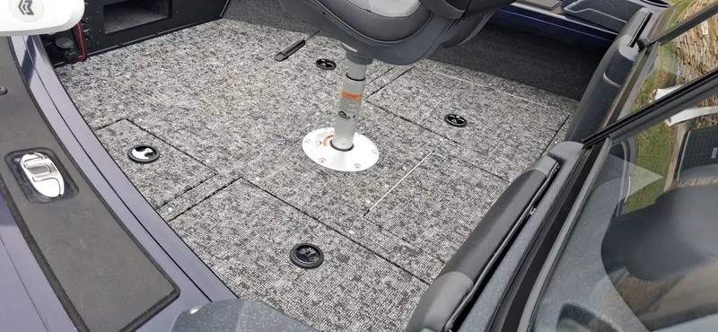 Slide: The Image of Interior of 2025 Tracker Targa V-19 Combo with gray carpet flooring. - 12