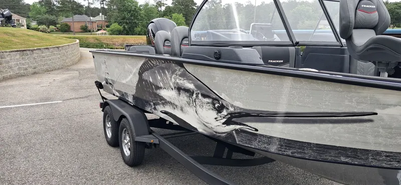 Slide: The Image of 2025 Tracker Targa V-19 Combo boat with marlin design on trailer. - 16
