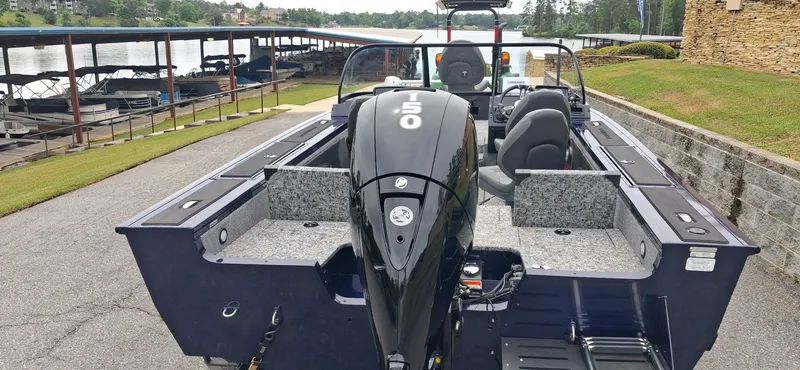 Slide: The Image of 2025 Tracker Targa V-19 Combo boat parked by the lakeside. - 7