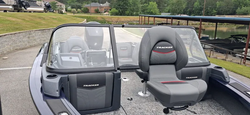 Slide: The Image of 2025 Tracker Targa V-19 Combo boat with gray seats at dock. - 9