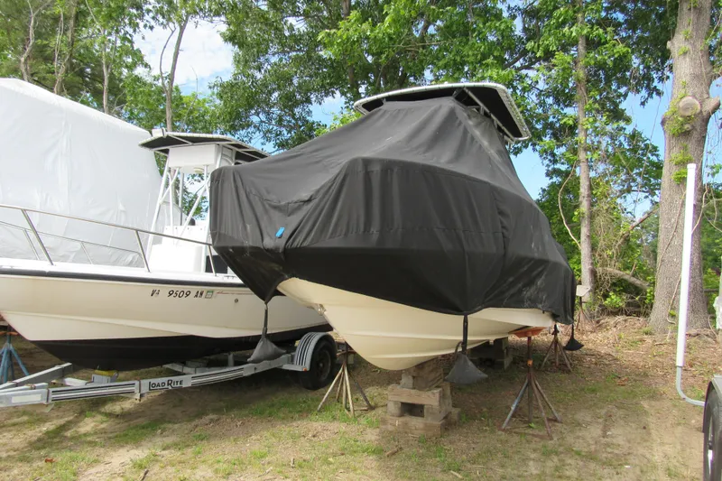 Slide: The Image of 2014 Boston Whaler 210 Dauntless boat covered, stored outdoors on blocks. - 5