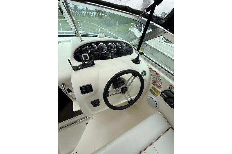 Slide: The Image of 1997 Sea Ray 240 Sundancer boat dashboard with steering wheel and instrument panel. - 12