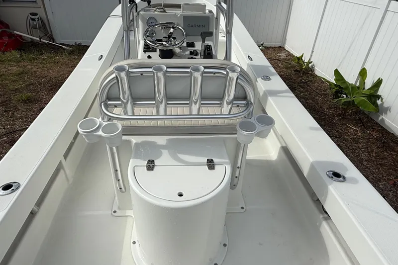 Slide: The Image of 2016 Panga 22 Boca Grande boat interior with rod holders and steering console. - 10