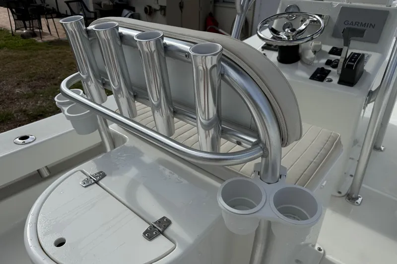 Slide: The Image of 2016 Panga 22 Boca Grande boat interior with rod holders and steering console. - 13