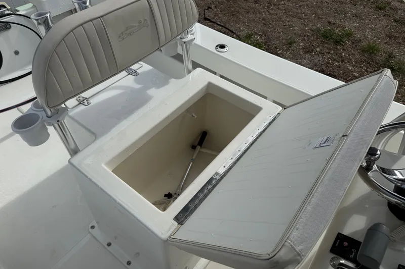 Slide: The Image of 2016 Panga 22 BOCA GRANDE boat with open storage compartment and cushioned seating. - 14