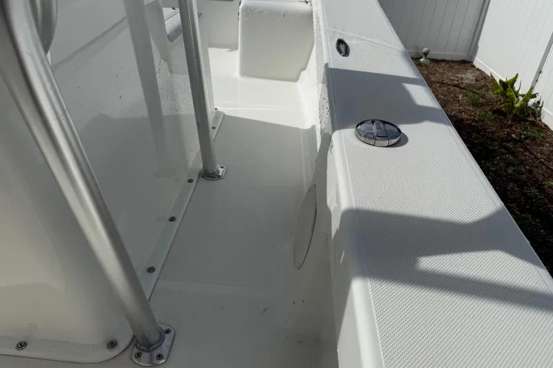 Slide: The Image of 2016 Panga 22 Boca Grande boat interior with stainless steel fittings and white deck. - 24